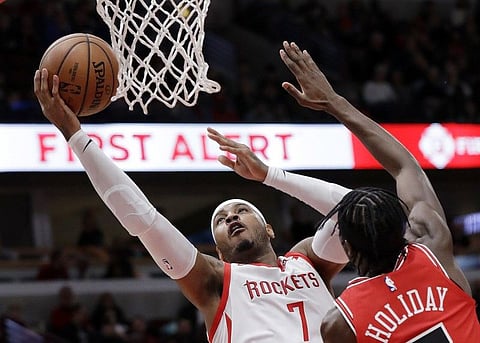 NEW YORK. In this November 3, 2018, file photo, Houston Rockets forward Carmelo Anthony (left) drives to the basket against Chicago Bulls forward Justin Holiday during the first half of an NBA basketball game in Chicago. A person familiar with the details said Anthony is returning to the NBA with the Portland Trail Blazers. The 10-time All-Star has not played since a short stint with the Rockets ended a little more than a year ago after just 10 games. (AP)