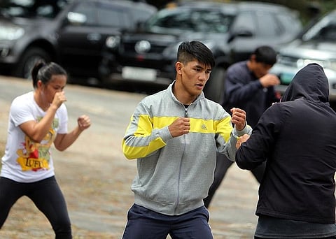 MANILA. Danny Kingad is joined in the background by Gina Iniong and Eduard Folyang as they gear up for ONE Championship's Fire & Fury at the Mall of Asia Arena January 31. (Photo by Roderick Osis)  