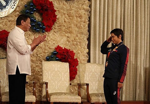 MANILA. President Rodrigo Roa Duterte gets a salute from weightlifting gold medalist Hidilyn Diaz during the awarding of the Order of Lapu-Lapu Rank of Kamagi to the 2019 Southeast Asian Games medalists at the Malacañan Palace on December 18, 2019. (Presidential photo)