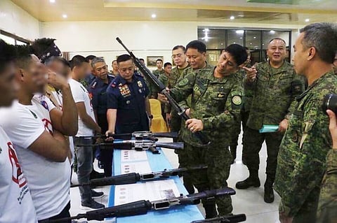 FORT MAGSAYSAY. Former rebels who used to be members of the Komiteng Larangang Gerilya Sierra Madre present to Northern Luzon Command Commander Lieutenant General Ramiro Manuel A. Rey (middle) the high-powered firearms that was discovered by security forces, from the information they gave, in a firearms cache in barangay Villa, Maria Aurora town in Aurora. (Contributed by 7th Infantry Division)