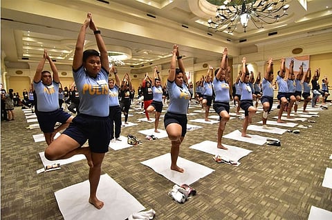 POLICE YOGA. Members of the Davao City Police Office execute the tree pose as they participate during last Sunday afternoon's International Yoga Day 2018 celebration together with 400 other participants at the Davao Convention Center in Davao City.