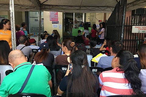DAVAO. Business permit renewal applicants hurry to pay for their tax obligations at the counters set up at the back of the City Treasurer's Office (CTO). (Photo by Roberto A. Gumba Jr.)