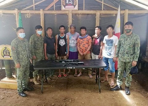 ZAMBOANGA. Six persons, including an alleged supplier of illegal drugs, surrender and turn over high-powered firearms Thursday, June 11, to authorities in Patikul, Sulu. A photo handout shows the drug surrenderers in a posterity photo with members of the Army's 45th Infantry Battalion.  (SunStar Zamboanga)