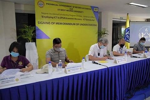 SCHOLARSHIP. Negros Occidental Governor Eugenio Jose Lacson (center) signs a Memorandum of Understanding with STI-West Negros University in Bacolod City for scholarship grants to the latter's ICT students last week. (Capitol Photo)