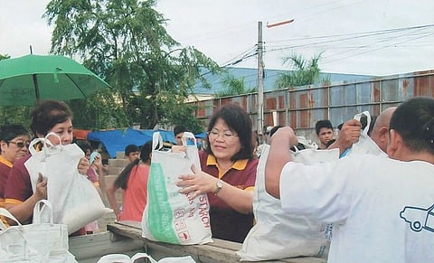 GIFTS. Fully loaded bags are given away by Zontian Filna Espina, as others line up.