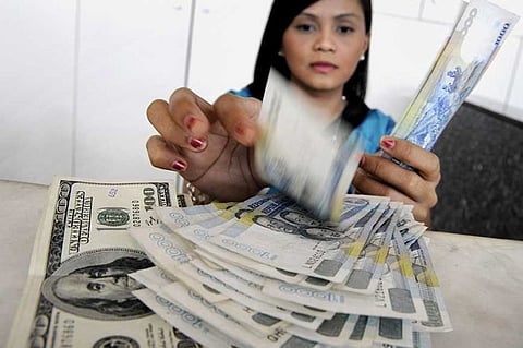 MANILA. In this file photo, a teller counts Philippine peso for a client selling US dollars. (File Photo)