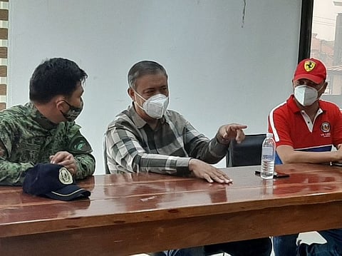 ANTI-COVID MEASURES. Mayor Danilo Guintu and chief of police Captain John Carlos Ornales discuss new anti-Covid-19 measures to be implemented in Masantol town. Listening is Vice Mayor Boboy Lacap. (Photo by Princess Clea Arcellaz) 