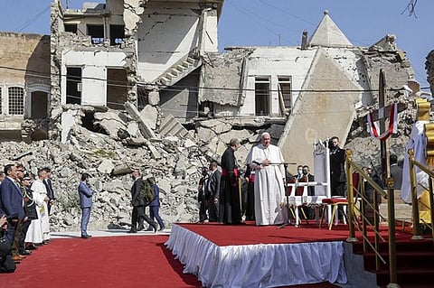 Pope Francis, surrounded by shells of destroyed churches, arrives to pray for the victims of war at Hosh al-Bieaa Church Square, in Mosul, Iraq, once the de-facto capital of IS, Sunday, March 7, 2021. The long 2014-2017 war to drive IS out left ransacked homes and charred or pulverized buildings around the north of Iraq, all sites Francis visited on Sunday. (AP Photo)