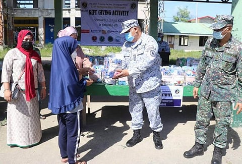 ZAMBOANGA. Some 300 residents of Mampang village, Zamboanga City benefitted Wednesday, June 9, from the gift-giving activity of the Naval Forces Western Mindanao (NFWM), which is in support to the Armed Forces of the Philippines' Kapwa ko Sagot ko program and is part of the celebration of the 123rd Philippine Navy Anniversary, which was commemorated on May 18. A photo handout shows an officer of the NFWM hands over to recipient packs of groceries. (SunStar Zamboanga)
