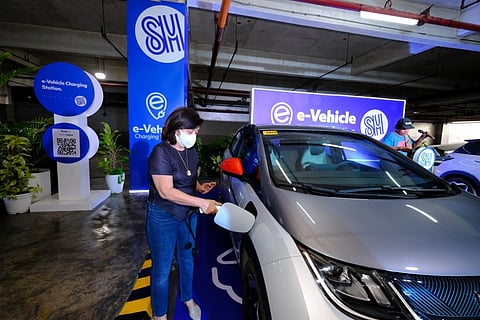 A motorist demonstrates the use of the newly launched electric vehicle (EV) charging station at SM Lanang Premier in Davao City. SM Supermalls has expanded its sustainability initiative by rolling out free-of-charge EV charging spots across its Mindanao properties, supporting the transition toward eco-friendly transport and green energy solutions. 