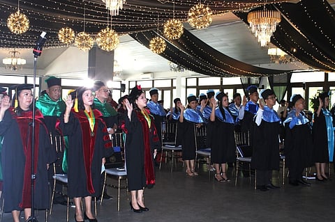 GRADUATES. Commencement Speaker Lizan Perante-Calina, Dean of the Graduate School of Public and Development Management at the Development Academy of the Philippines, gives her message to the 63 advanced education graduates of Carlos Hilado Memorial State University, July 8, at Nature's Village Resort in Talisay City, Negros Occidental. (CHMSU-CIER Photo)