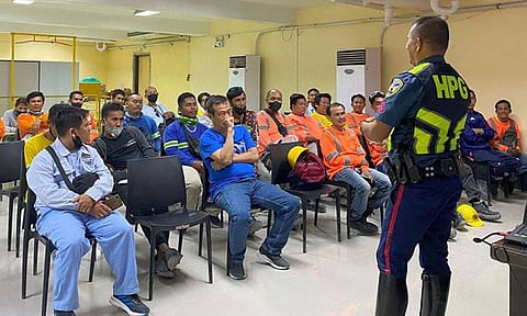 DRIVE SAFELY. EMS Wilfredo Ator of the Highway Patrol Group 7 explains to Taiheiyo Cement Philippines Inc. employees, outsourced workers, security guards and hauler drivers the road safety rules under Republic Act 4316. / TAIHEIYO CEMENT PHILIPPINES