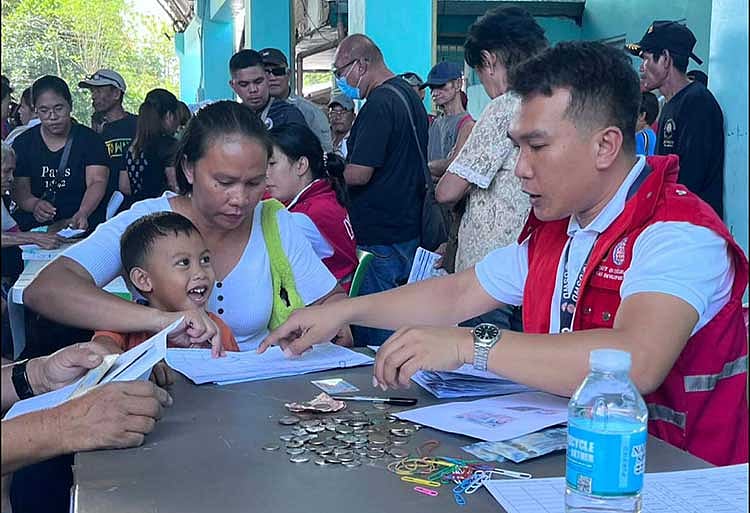 DSWD 6 distributes emergency cash aid to storm-hit families