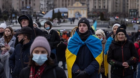 KYIV, UKRAINE - FEBRUARY 20: People sing the Ukrainian national anthem during a rally in support of Ukraine held during Maidan Revolution commemoration ceremonies on February 20, 2022 in Kyiv, Ukraine. In February 2014, the months-long Euromaidan protests culminated in violent clashes between protesters and riot police, leading to the deaths of over 100 people and the ousting of president Viktor Yanukovych, who had sparked the protests by rejecting a pact with the European Union in favor of closer ties with Russia. Eight years later, the country again finds itself at center stage in the geopolitical tussle between Russia and the West.  (Photo by Chris McGrath/Getty Images)