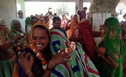 Women and men celebrated their newfound unity by garlanding and embracing each other.