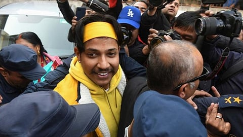 Sandeep Lamichhane (L) is escorted by police outside the districtl court following his release on bail. 