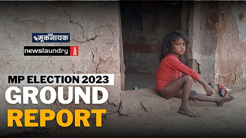 A tribal child sitting on the doorstep of his house