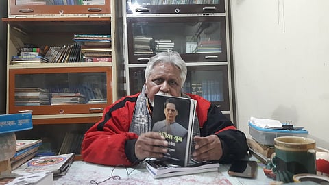 H.L Dusadh holding a book written by him on Sonia Gandhi