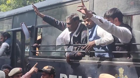 The protestors being taken away in a police bus. 
