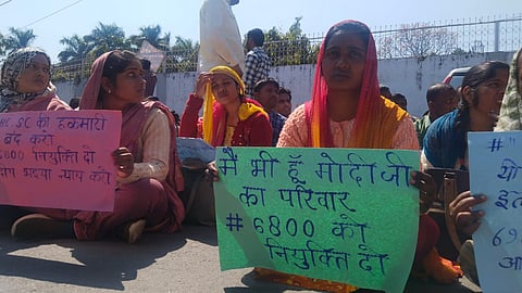Candidates from reserved categories aspiring for recruitment of 69,000 teachers vacancies gathered at the Education Minister's residence, on Thursday, holding placards that read, "We too are from Modi's family." 

