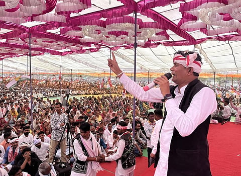A BAP leader addressing a massive crowd during an election rally. 