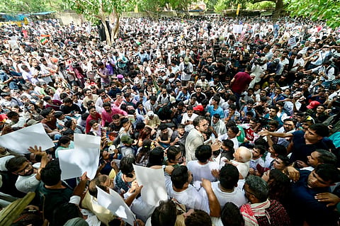 Eyewitnesses and live visuals from the ground show elderly protesters in traditional attire holding handwritten placards criticizing the education system and demanding systemic reforms.