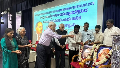 A Bangalore public hearing exposes severe systemic and judicial failures in the PTCL Act implementation, depriving Dalit and Adivasi communities of land rights.