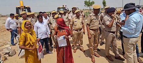  Women and girls from the affected families staged protests  some climbing onto tin sheds and rooftops, while others refused to vacate their huts, leading to intervention by female police personnel.