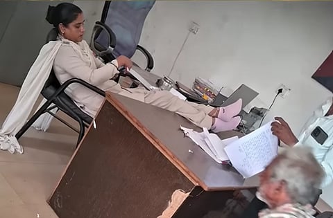 Constable Reena Garg was suspended after a photograph showing her with both feet on a desk in the presence of an elderly complainant went viral on social media.