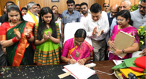 Minister Konda Surekha signing the order to double ex-gratia