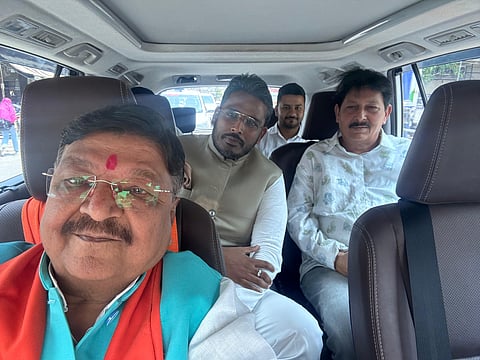 Akshay Kanti Bam posing with a BJP minister Kailash Vijayvargiya