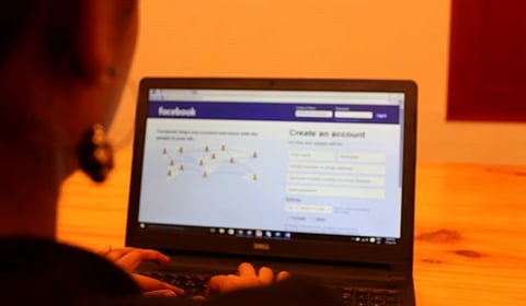 Woman using Facebook