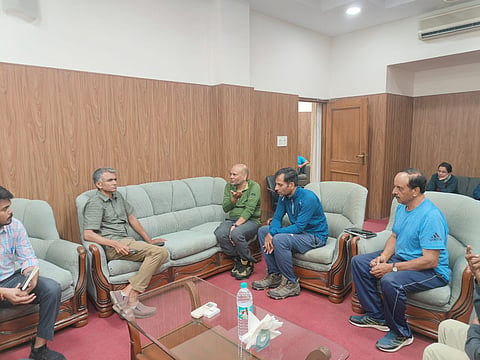 Minister Krishna Byre Gowda meeting the rescued trekkers at Dehradun guest house
