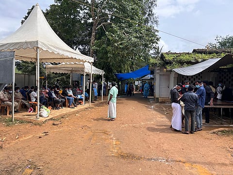Relatives and volunteers waiting outside the Family Health Centre in Meppadi