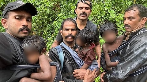 Forest officers with the children after the rescue operation.