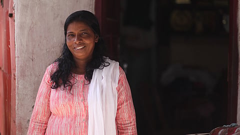 Dhanuja Kumari in front of her house in Chengalchoola