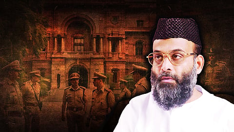 A close-up of Abdul Nasir Maudany in white on the right against a backdrop of a court building and police personnel