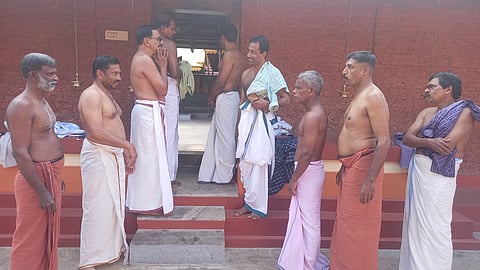 Image featuring nine devotees standing at the temple. 