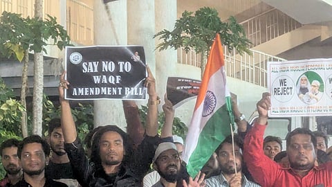 Protesters holding up placards against the new Waqf law at the AIMIM headquarters in Hyderabad