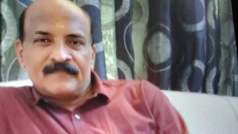 Image featuring Ramachandran wearing a maroon colour shirt 