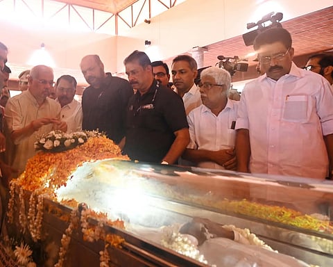 Image featuring Kerala Governor Rajendra Arlekar paying last respects to Ramachandran 