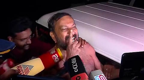An image featuring Shajan Scaria during arrest, without wearing a shirt.  