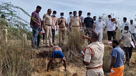 Tirupati police digging up the body of nine-year-old Venkatesh. 