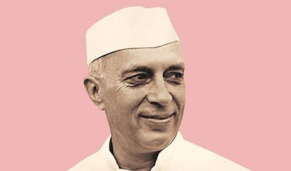 A picture of a smiling Nehru. The picture has a pink background