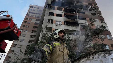 A firefighter at the scene of an explosion at a residential compound in northern Tehran that was believed to have been struck by Israel. Vahid Salemi/AP