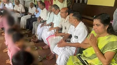 Students kneeling before a row of seated elders and washing their feet as part of a ‘Guru Pada Pooja’ ceremony at a private school in Kasaragod.