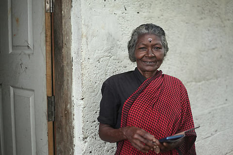 Sarassu, a 69 year old daily wage labourer in Pullampara, with her smartphone