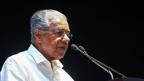 Image featuring Kerala Chief Minister Pinarayi Vijayan wearing a white shirt  