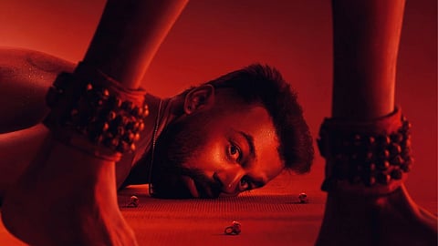 Pranav Mohanlal is lying on the floor as someone wearing an anklet walks by.