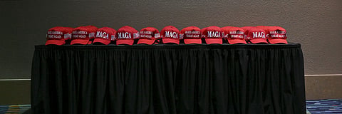 MAGA hats are placed on a table at an election night party in West Palm Beach, Fla., on Nov. 5, 2024. 
